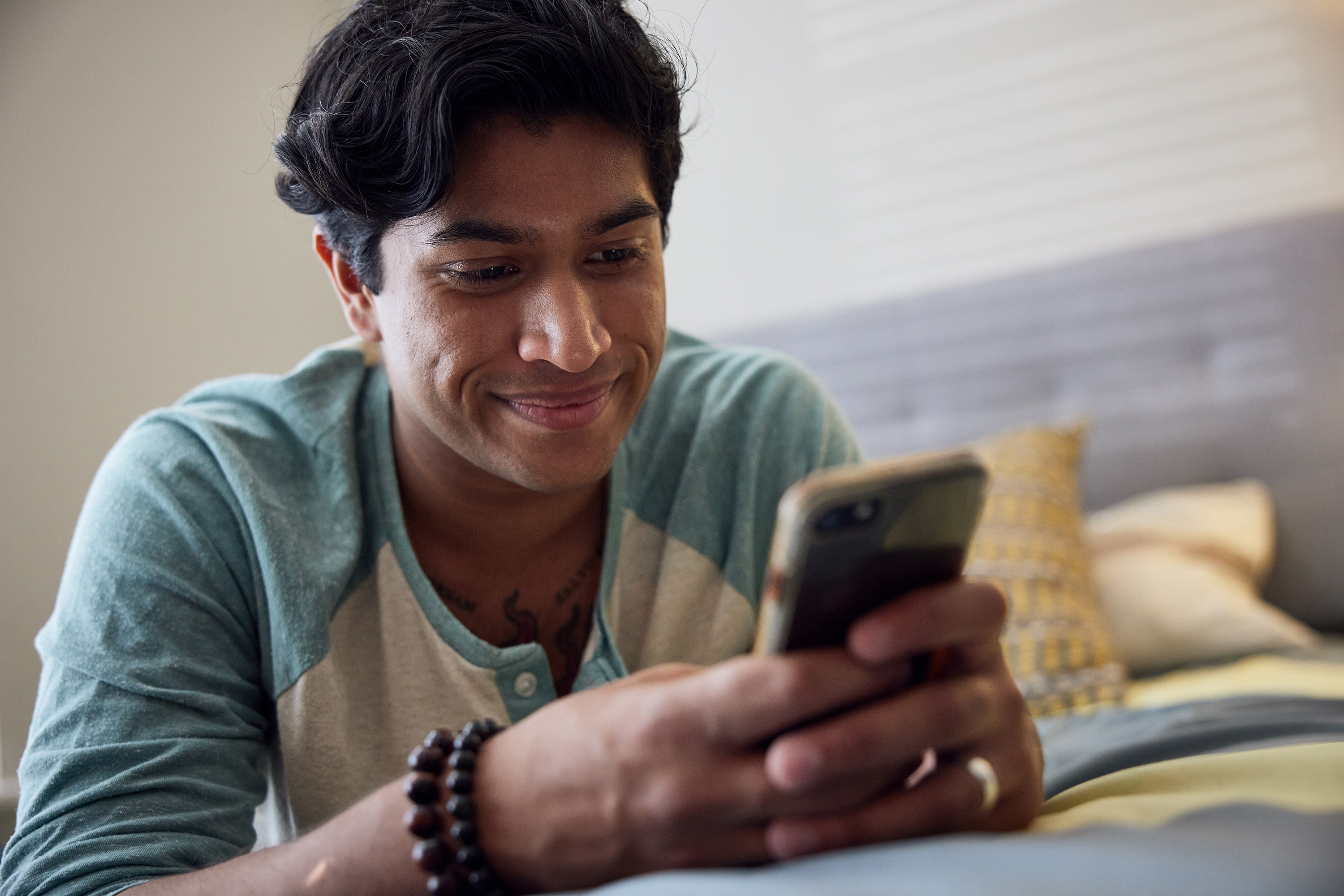 man holding his iPhone at home